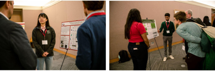 Two students stand next to their posters and present their research